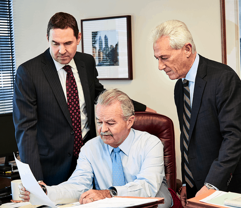 hgsk lawyers reviewing paperwork at a desk